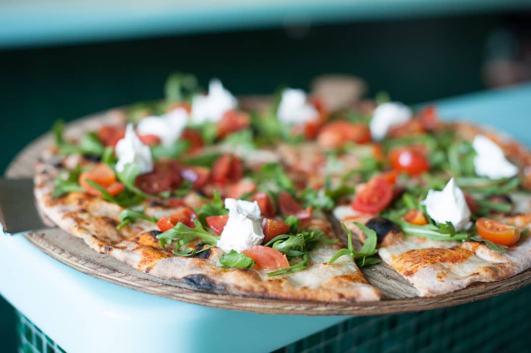 Thin, crispy 40 cm pizza with cherry tomatoes and rocket